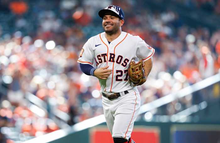 José Altuve smiles as he jogs off the field at Minute Maid Park.